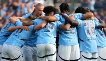 Manchester City FC players huddle up before a soccer game against AC Milan, Saturday, July 27, 2024, in New York. (AP Photo/Pamela Smith)