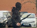 Shocking moment masked thug in balaclava brandishes two machetes outside school in Nottingham