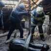 In this photo provided by the Ukrainian Emergency Service, emergency services personnel remove part of a Russian missile that hit an apartment house during massive missile attack in Kyiv, Ukraine, Sunday, Nov. 17, 2024. (Ukrainian Emergency Service via AP)