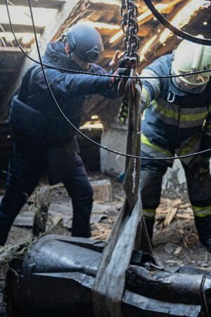 In this photo provided by the Ukrainian Emergency Service, emergency services personnel remove part of a Russian missile that hit an apartment house during massive missile attack in Kyiv, Ukraine, Sunday, Nov. 17, 2024. (Ukrainian Emergency Service via AP)