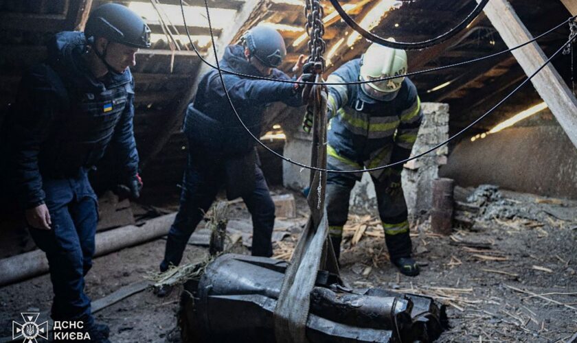 In this photo provided by the Ukrainian Emergency Service, emergency services personnel remove part of a Russian missile that hit an apartment house during massive missile attack in Kyiv, Ukraine, Sunday, Nov. 17, 2024. (Ukrainian Emergency Service via AP)