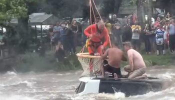 Helicopter rescuer saves two men from submerged car during horror floods