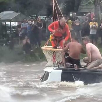 Helicopter rescuer saves two men from submerged car during horror floods