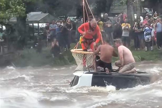 Helicopter rescuer saves two men from submerged car during horror floods