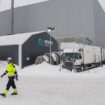 Workers walk at the site of the Northvolt Ett factory in Skelleftea, north Sweden on February 23, 2022. Located in Skelleftea, around 200km from the artic circle in Sweden, the Northvolt 1 Gigafactory is meant to produce electric batteries for 600 000 vehicles a year. The site is already partially operating, although it is still under construction. (Photo by Jonathan NACKSTRAND / AFP)