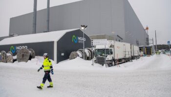 Workers walk at the site of the Northvolt Ett factory in Skelleftea, north Sweden on February 23, 2022. Located in Skelleftea, around 200km from the artic circle in Sweden, the Northvolt 1 Gigafactory is meant to produce electric batteries for 600 000 vehicles a year. The site is already partially operating, although it is still under construction. (Photo by Jonathan NACKSTRAND / AFP)