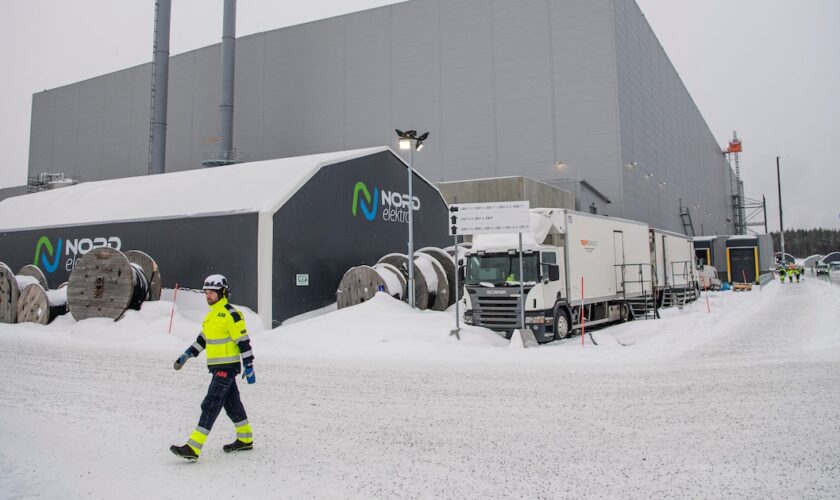 Workers walk at the site of the Northvolt Ett factory in Skelleftea, north Sweden on February 23, 2022. Located in Skelleftea, around 200km from the artic circle in Sweden, the Northvolt 1 Gigafactory is meant to produce electric batteries for 600 000 vehicles a year. The site is already partially operating, although it is still under construction. (Photo by Jonathan NACKSTRAND / AFP)