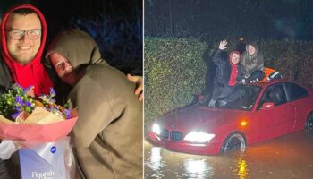 Bizarre moment boyfriend proposes to partner on roof of their car during flood