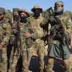 Syrian opposition fighters stand in formation after entering the village of Anjara, western outskirts of Aleppo, Syria, Thursday Nov. 28, 2024, part of  their major offensive on government-controlled areas in the country's northwestern Syria. (AP Photo/Omar Albam)