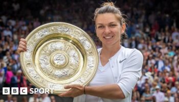 Simona Halep of Romania holds the trophy at Wimbledon