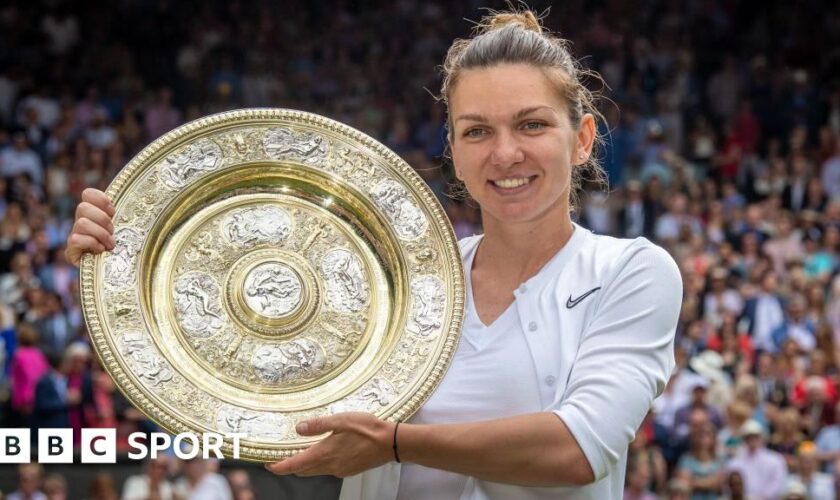 Simona Halep of Romania holds the trophy at Wimbledon