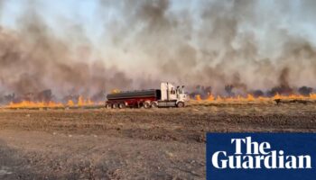 Heatwave sweeps across large parts of Australia as bushfire threatens Queensland border town