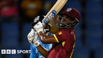 Evin Lewis hits a boundary against England