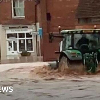 Man arrested over tractor drive through floods