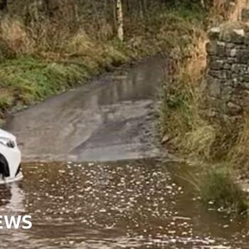 Man dies after car enters flooded ford