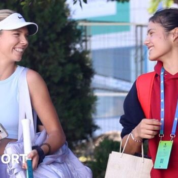 Katie Boulter and Emma Raducanu smile at each other on the way to Billie Jean King Cup practice