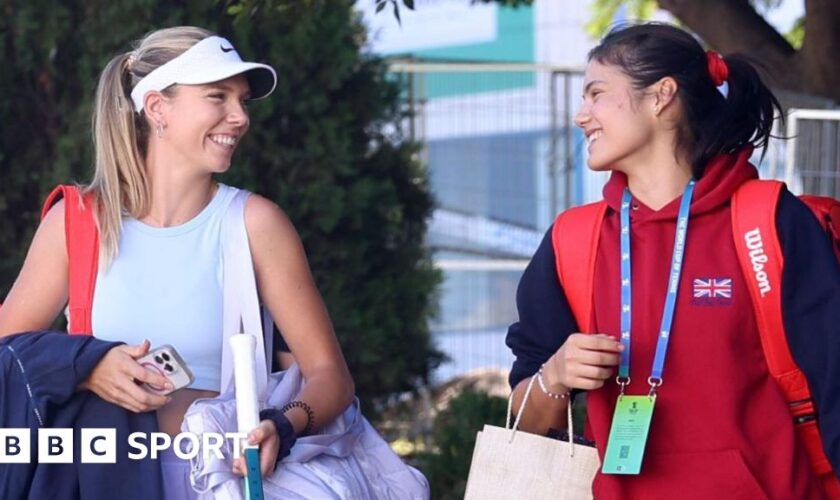 Katie Boulter and Emma Raducanu smile at each other on the way to Billie Jean King Cup practice