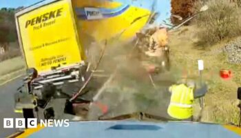 Watch: Moment road worker dodges high-speed truck crash