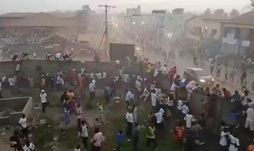 Dozens crushed to death in stampede at Guinea football match as pitch invasion ends in tragedy