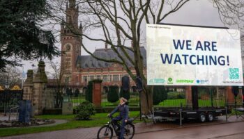 "We are Watching!" ist auf einem Plakat vor dem Internationalen Gerichtshof zu lesen: Das höchste UN-Gericht befasst sich mit Kl