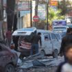 People walk past a damaged site in Aleppo. Pic: Reuters