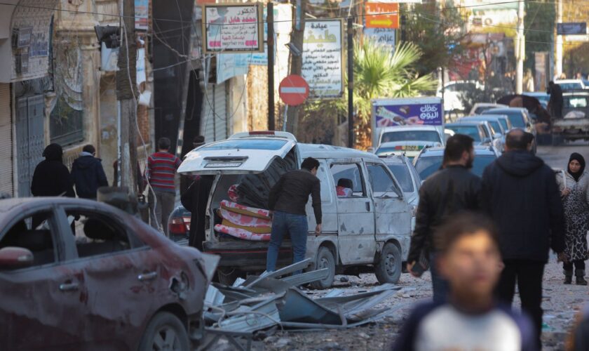 People walk past a damaged site in Aleppo. Pic: Reuters