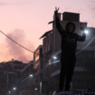 A young boy celebrates the capture of the city by rebel forces