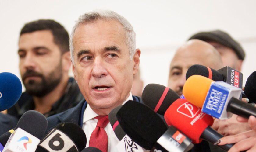 Calin Georgescu, an independent candidate for president who came first after the first round of presidential election, speaks to media after casting his vote in the country's parliamentary election in Mogosoaia, Romania, Sunday, Dec. 1, 2024. (AP Photo/Vadim Ghirda)