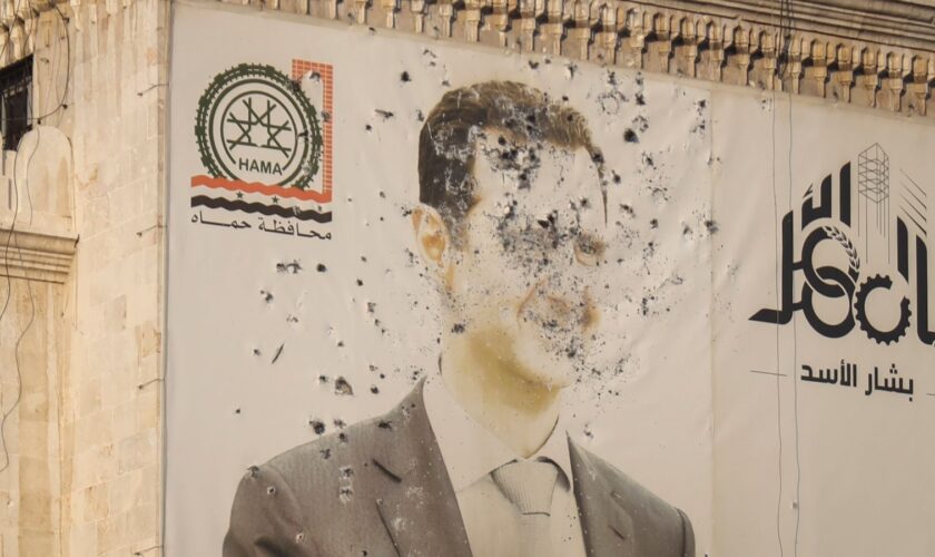 An image of Syrian President Bashar al Assad riddled with bullets at the provincial government office building in Hama. Pic: AP