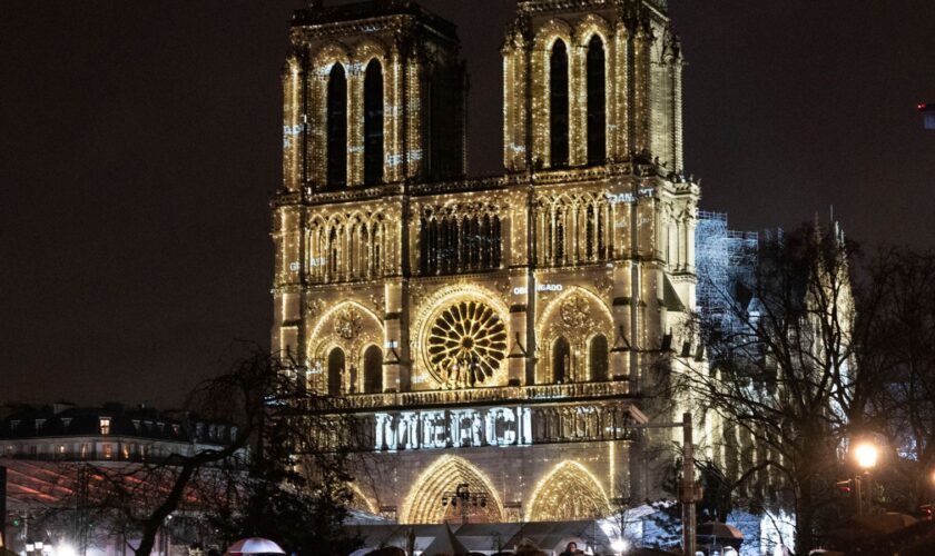 The word 'merci' was projected onto the front of the cathedral. Pic: AP