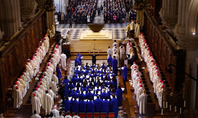 Clergy members and singers of the choir of the Maitrise de Notre-Dame sit in the nave during an inaugural Mass, with the consecration of the high altar, at the Notre-Dame de Paris Cathedral, five-and-a-half years after a fire ravaged the Gothic masterpiece, as part of ceremonies to mark the Cathedral's reopening after its restoration, in Paris, France, Sunday, Dec. 8, 2024. (Sarah Meyssonnier/Pool Photo via AP)