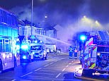 Moment terraced house goes up in flames after massive explosion in London: Sixty firefighters battling to get blaze under control