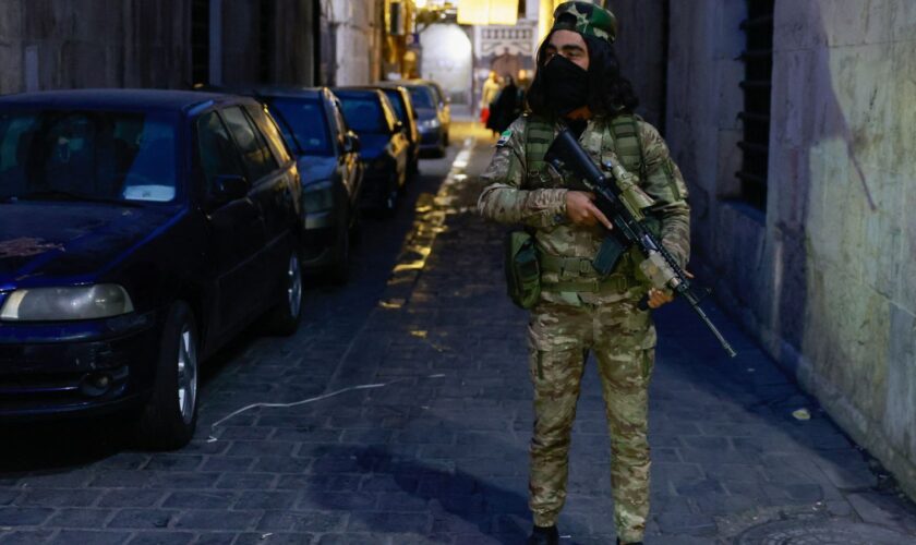 A rebel fighter stands guard in Damascus old city. Pic: Reuters/Ammar Awad