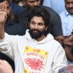 Indian Southern film actor Allu Arjun, center, greets his fans in Hyderabad, India, Friday, Dec. 13, 2024, as he leaves a hospital where he was taken for medical checkup by policemen before arresting him after his appearance at a film screening allegedly led to a crush of fans in which a woman died. (AP Photo)