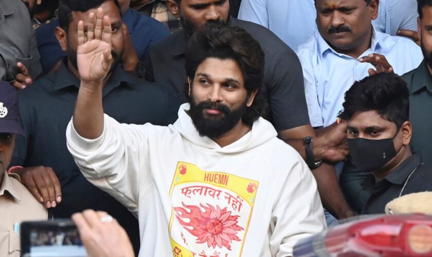 Indian Southern film actor Allu Arjun, center, greets his fans in Hyderabad, India, Friday, Dec. 13, 2024, as he leaves a hospital where he was taken for medical checkup by policemen before arresting him after his appearance at a film screening allegedly led to a crush of fans in which a woman died. (AP Photo)