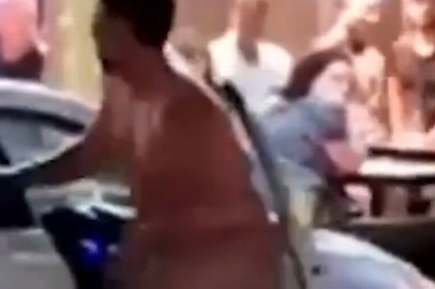 Wild moment naked man on 'rampage' sticks tongue out at stunned onlookers