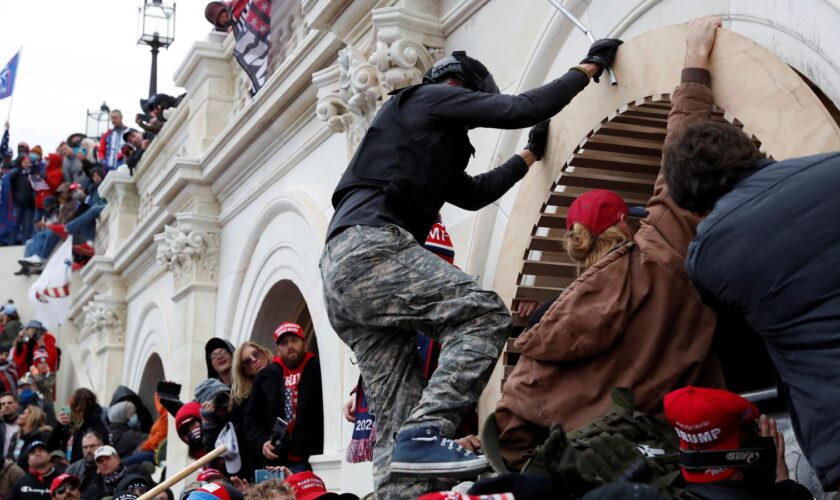 Trump supporters scale the wall of the Capitol Building in Washington DC on 6 January 2021. Pic: Reuters