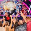 Chris McCausland celebrates his win, as Dianne Buswell holds the glitterball trophy aloft. Pic: PA