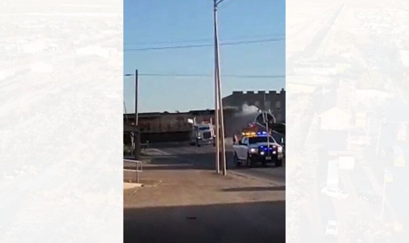 Texas train derails after hitting tractor-trailer, barrels into city building: video