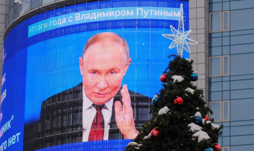 An electronic screen, which shows an image of Russian President Vladimir Putin and a quote from his annual televised year-end press conference and phone-in, is on display on the facade of a building behind a New Year and Christmas tree in a street in Moscow, Russia December 19, 2024. REUTERS/Shamil Zhumatov