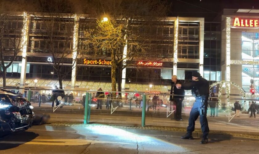 Police officers arrest a suspect at the Christmas market. Pic: Privat/picture-alliance/dpa/AP Images