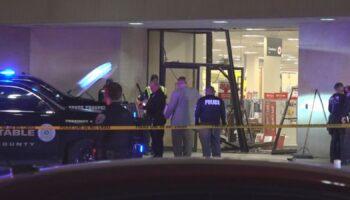 This image taken from video provided by KCEN-TV shows police responding after a man drove a vehicle into a JCPenney at a shopping mall Saturday, Dec. 21, 2024, in Killeen, Texas. (KCEN-TV via AP)