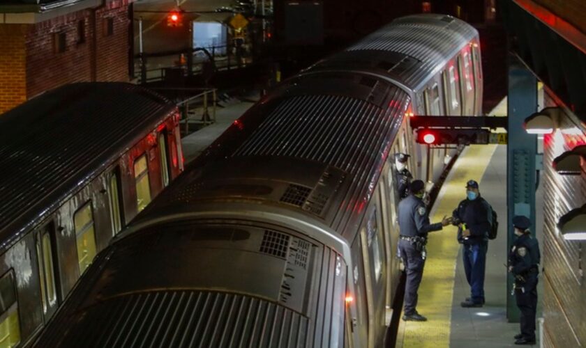 FILE - New York Police officers clear a train at the Coney Island Stillwell Avenue Terminal, May 5, 2020, in the Brooklyn borough of New York. (AP Photo/Frank Franklin II, file)