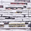 An aerial view of parked trolley buses during heavy snowfall in Sarajevo, Bosnia, Tuesday, Dec. 24, 2024. (AP Photo/Armin Durgut)