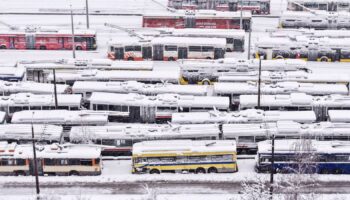 An aerial view of parked trolley buses during heavy snowfall in Sarajevo, Bosnia, Tuesday, Dec. 24, 2024. (AP Photo/Armin Durgut)