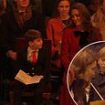 Sweet moment Prince Louis shares comforting words with Kate Middleton at her Christmas carol concert, according to a lip reader - as he excitedly places heartwarming note to his 'granny and grandpa' on 'kindness tree'