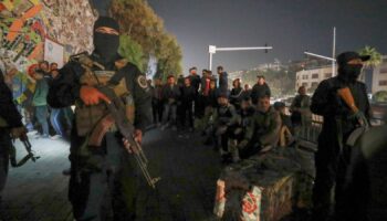 Security forces of the new Syrian government secure the area around group of Alawite protesters in the Mazzeh district in Damascus. Pic: AP