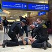 Dramatic moment armed vigilante is arrested at Phoenix Airport after shooting that left several injured