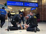 Dramatic moment armed vigilante is arrested at Phoenix Airport after shooting that left several injured