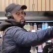 Watch moment relaxed M&S shoplifter casually stuffs his bag with goods before boldly shoving past outraged staff to make his escape